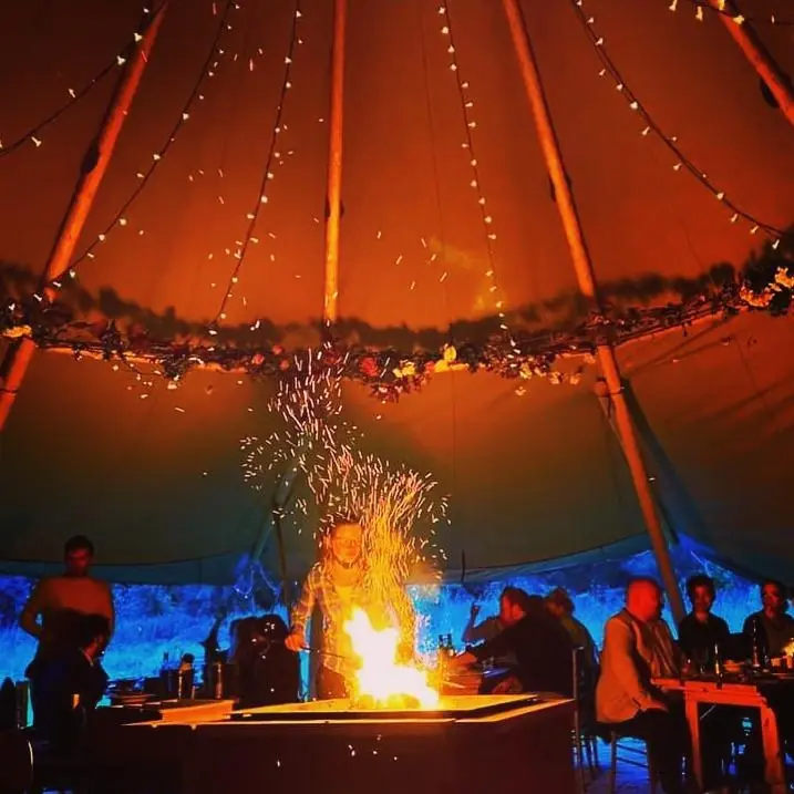 Fairy lights, firepit, and meadow setting