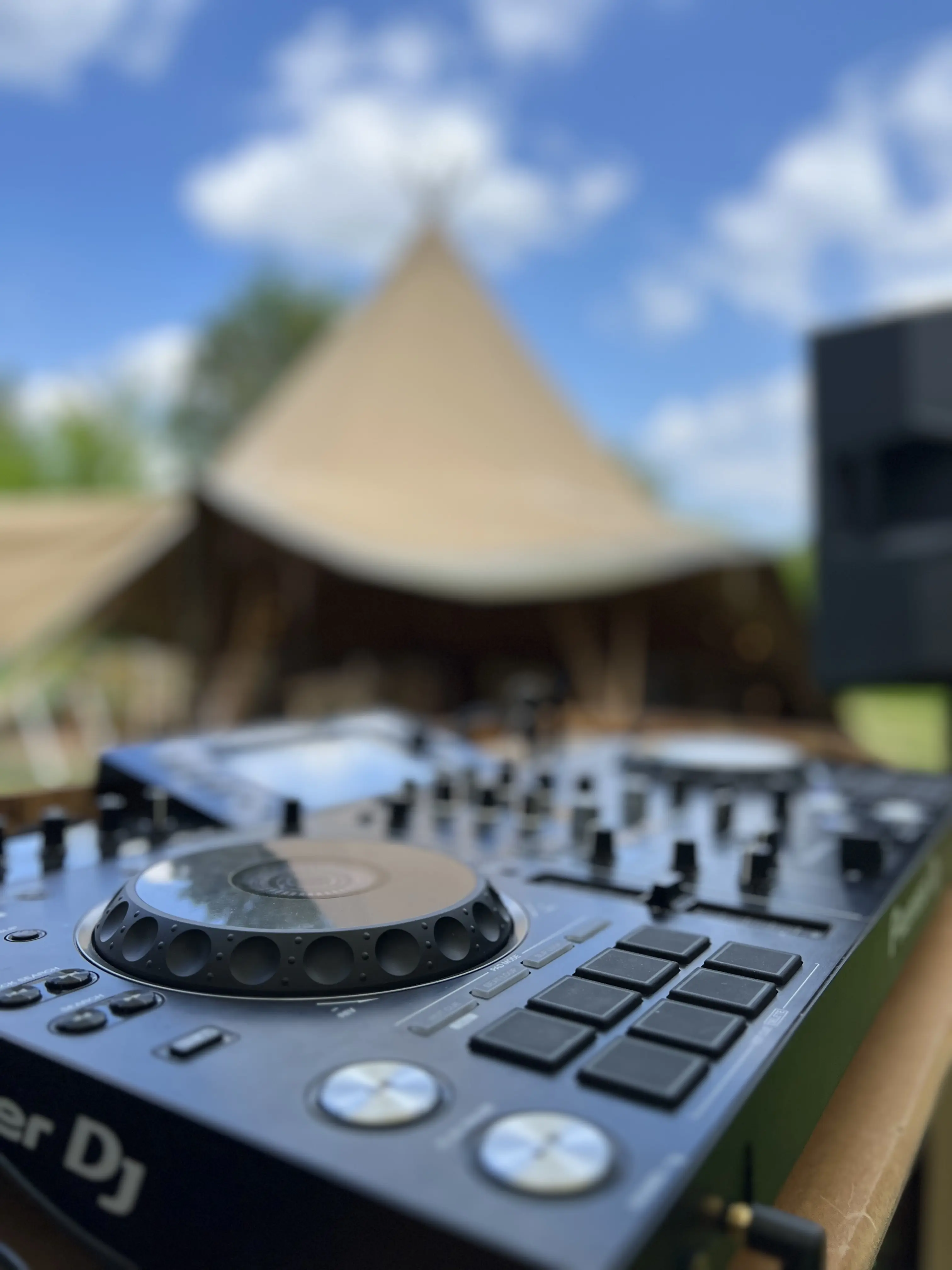 DJ decks with tipi in the background