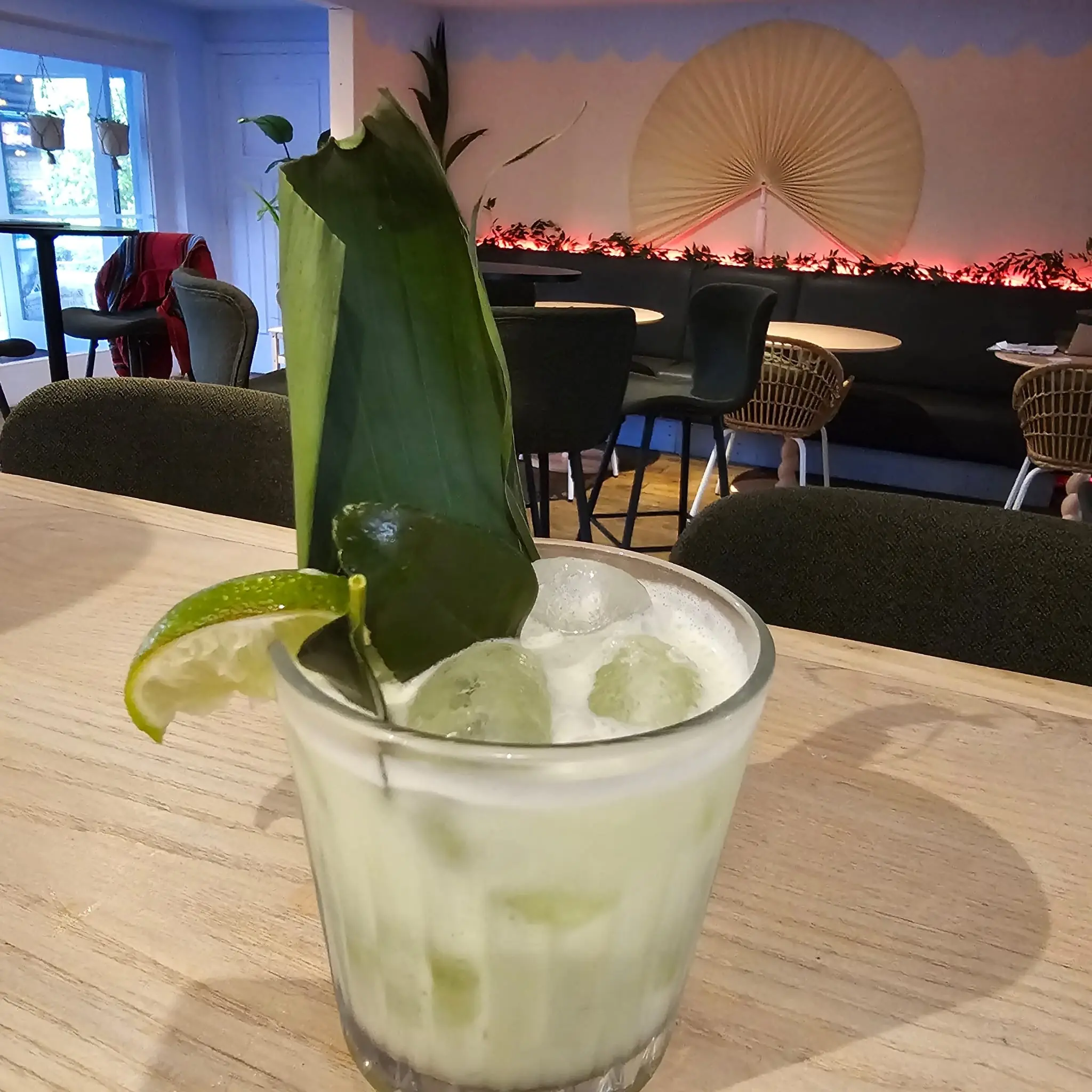 Tropical cocktail with pandan leaf garnish